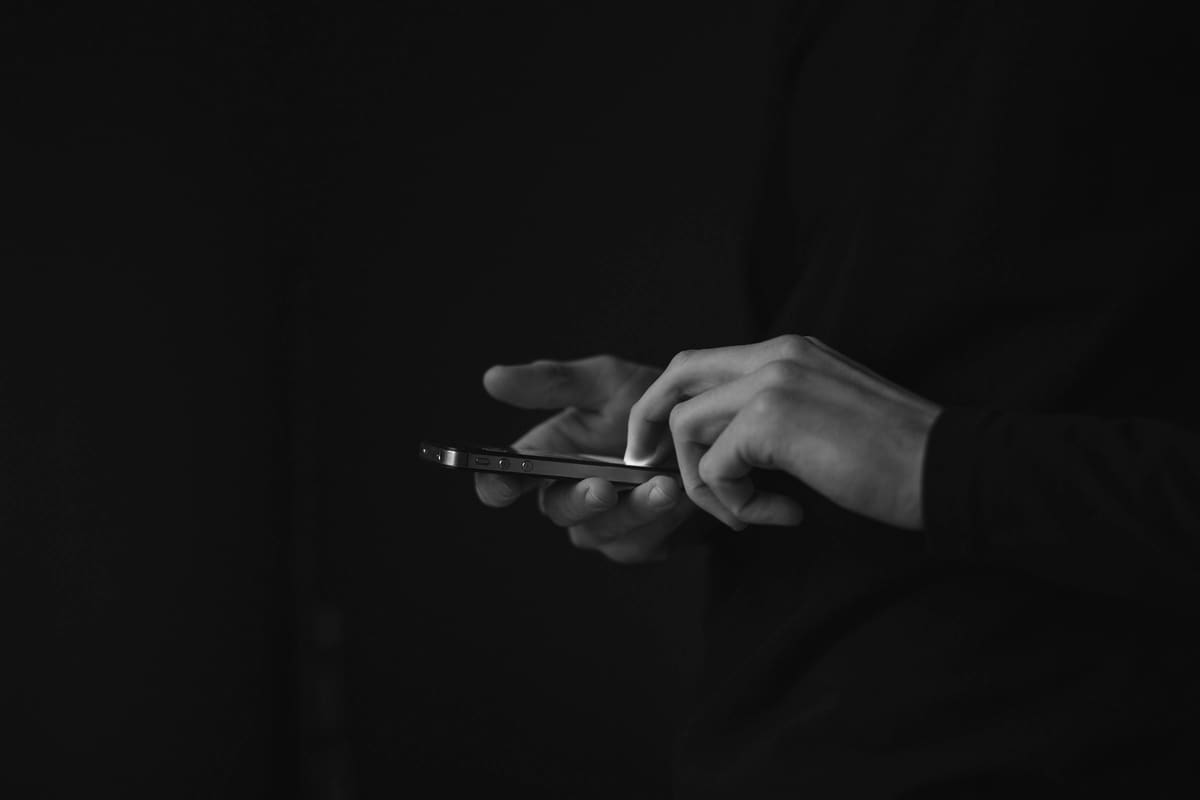 Hands using a phone in low light
